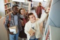 Group of Students Choosing Books in Library Royalty Free Stock Photo