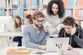 Group of students connecting with a laptop Royalty Free Stock Photo