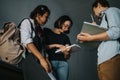 Group of students discussing schoolwork in the hallway between classes Royalty Free Stock Photo