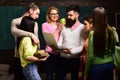 Group of students, groupmates spend time with teacher, lecturer, professor. Students, scientists studying after classes Royalty Free Stock Photo