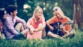 A group of students with a guitar resting in the Park Royalty Free Stock Photo