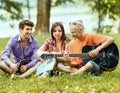Group of students with guitar resting in the Park on Sunny Royalty Free Stock Photo