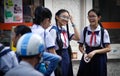 A group of students of a high school girl with red Soviet ties tie at a break and laugh merrily