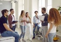 Group of students listening a professor explaining something and showing a book. Royalty Free Stock Photo