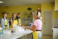 Group of students listening woman chef cooking lesson Royalty Free Stock Photo