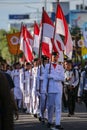 Group of students marching with Indonesian flag on National Independence Day in Yogyakarta, 17 August 2021