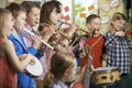 Group Of Students Playing In School Orchestra Together