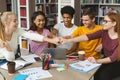 Group of students putting their fists together in library