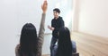 Group Students raise their hands to ask a friend questions for teaching at whiteboard in classroom