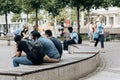 A group of students sits on a bench in a city park in Leipzig in Germany. Royalty Free Stock Photo