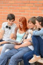 Group of students sitting bench outside college