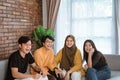 Group of students sitting together on the couch laughing together Royalty Free Stock Photo