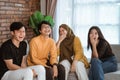 Group of students sitting together on the couch laughing together Royalty Free Stock Photo