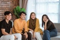 Group of students sitting together on the couch laughing together Royalty Free Stock Photo