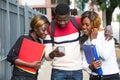 Group of students with mobile phone, smiling Royalty Free Stock Photo