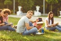 A group of students studying books sitting in a city park. Royalty Free Stock Photo