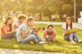 A group of students studying books sitting in a city park. Royalty Free Stock Photo