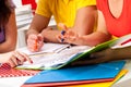 Group of students studying from notes Royalty Free Stock Photo