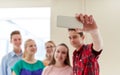 Group of students taking selfie with smartphone Royalty Free Stock Photo