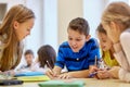 Group of students talking and writing at school Royalty Free Stock Photo