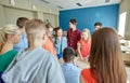 Group of students and teacher at school classroom