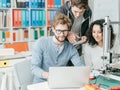 Group of students using a 3D printer and a laptop Royalty Free Stock Photo