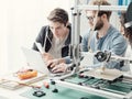 Group of students using a 3D printer and a laptop Royalty Free Stock Photo