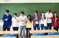 Group of students using smart mobile phones in classroom Royalty Free Stock Photo