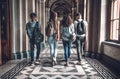 Group of students are walking in university hall and chatting. Royalty Free Stock Photo
