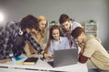 Group of students working on a joint university project sitting at a laptop in the classroom. Royalty Free Stock Photo