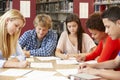 Group of students working together in library Royalty Free Stock Photo