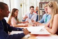 Group Of Students Working Together In Library With Teacher Royalty Free Stock Photo