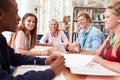 Group Of Students Working Together In Library With Teacher Royalty Free Stock Photo