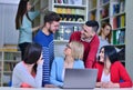 Group Of Students Working Together In Library With Teacher Royalty Free Stock Photo