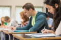 Group of students writing notes in classroom Royalty Free Stock Photo