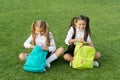 Group study outdoors girls classmates with backpacks, unpacking backpack concept