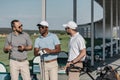 Group of stylish golf players talking before game