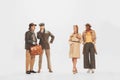 Group of stylish people in autumn outift, jackets and coats posing over white studio background