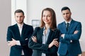 Group of successful business team and their pretty leader in front Royalty Free Stock Photo