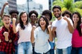 Group of successful cheering latin and caucasian and hispanic and african american young adults Royalty Free Stock Photo