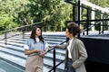 Group of successful young business people, leaders in marketing and motivation, stand in front of office building and consult Royalty Free Stock Photo