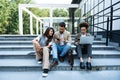 Group of successful young business people, leaders in marketing and motivation, stand in front of office building and consult Royalty Free Stock Photo