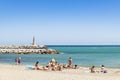 Sunbathing women Plaza beach Puerto BanÃÂºs Spain