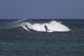 Group of surfers in Hawaii over the chasing waves in Kauai, Hawaii Royalty Free Stock Photo