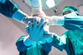 Group Surgeon doctor joining hands before Patient surgery in hospital operating room. Royalty Free Stock Photo