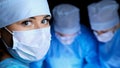 Group of surgeons in masks performing operation. Medicine, surgery and emergency help concepts Royalty Free Stock Photo