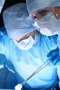 Group of surgeons in masks performing operation. Medicine, surgery and emergency help concepts Royalty Free Stock Photo