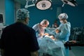 Group of surgeons in operating theater. Medical team performing surgery in operation room. Royalty Free Stock Photo