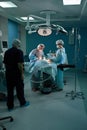 Group of surgeons in operating theater. Medical team performing surgery in operation room. Royalty Free Stock Photo