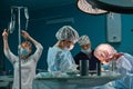 Group of surgeons in operating theater. Medical team performing surgery in operation room. Royalty Free Stock Photo